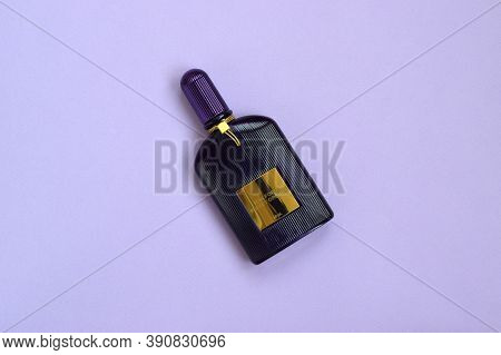 Tom Ford Velvet Orchid Fragrance Perfume Bottle Lies On Light Lilac Background. Tom Ford Is American