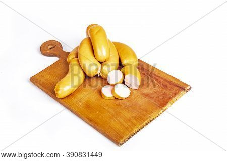 Shooting In The Studio. Meat Products, Semi-finished Products. Sausage Pork Sausages On A Wooden Tra