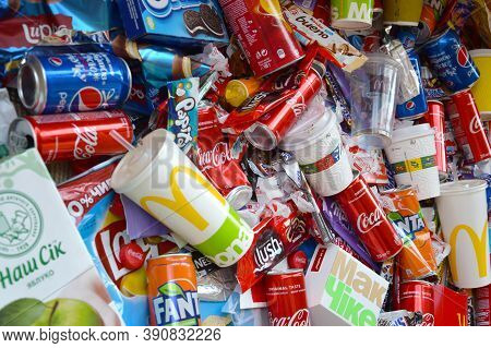 Many Wrappings And Cans From Used Products By Famous Worldwide Brands. Pattern Of Trash Of Various C