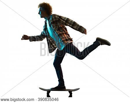 one cauacsian young man skateboarder Skateboarding in studio silhouette shadow isolated on white background