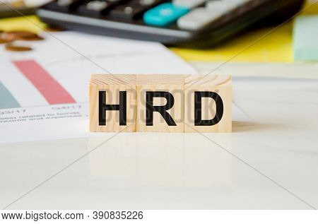 Hrd Word Written On A Wooden Block In The Background Of A Calculator. Faq Text On Table, Concept.
