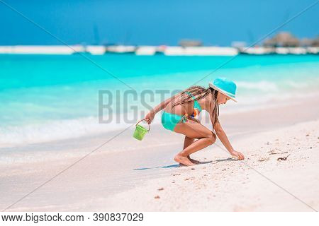 Adorable Active Little Girl At Beach During Summer Vacation