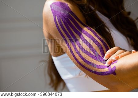 Sporty Girl With Kinesio Tape On Her Arm. Fixation Of The Muscles Of The Biceps With A Plaster For K