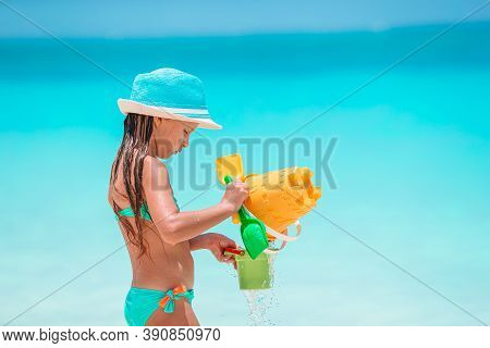 Adorable Active Little Girl At Beach During Summer Vacation
