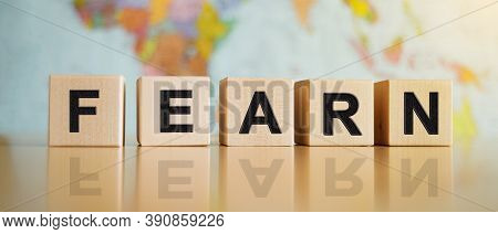 The Word Fearn Written On Wooden Cubes Isolated On A Political Map Background