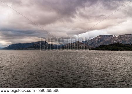 Sarmiento Channel, Chile - December 11, 2008: Amalia Glacier And Fjord. Thick Brown Cloudscape Above