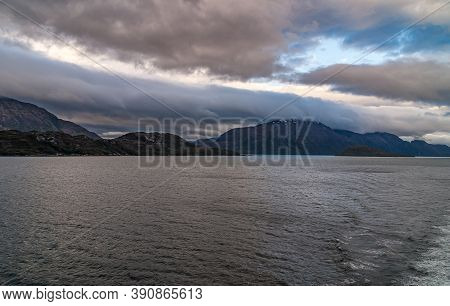 Sarmiento Channel, Chile - December 11, 2008: Amalia Glacier And Fjord. Thick Brown Cloudscape Above