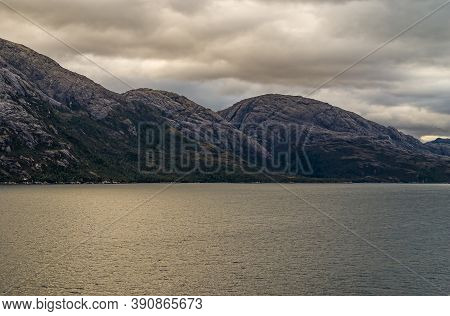 Sarmiento Channel, Chile - December 11, 2008: Amalia Glacier And Fjord. Brown Cloudscape Hangs Over 