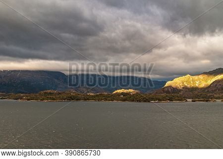 Sarmiento Channel, Chile - December 11, 2008: Amalia Glacier And Fjord. Patch Of Sunshine On Rocky S