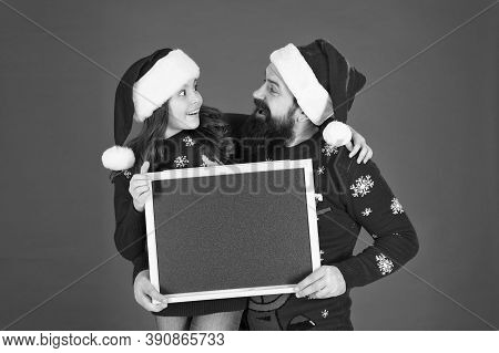 New Year And Christmas Publicity. Happy Family Hold Blank Publicity Board. New Year And Xmas Celebra