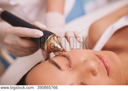 Cropped Close Up Of A Young Asian Woman Enjoying Ultrasound Cavitation Procedure At Beauty Salon. No