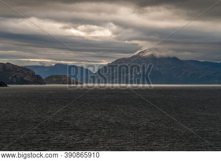 Sarmiento Channel, Chile - December 11, 2008: Amalia Glacier And Fjord. Sunlight Tries To Bread Thro