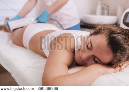 Happy Mature Relaxed Woman Getting Endospheres Therapy Massage By Professional Beautician. Cosmetolo