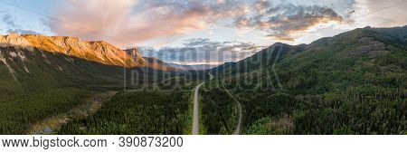 Picturesque Panoramic View Of Scenic Highway Surrounded By Golden Rocky Mountains At Sunset In Canad