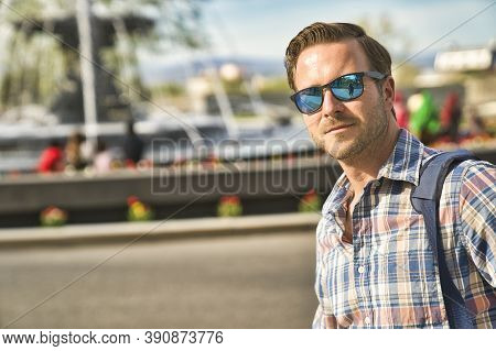 A Nice Tourist Man With Tourny Fountain On The Back