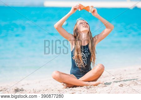 Adorable Active Little Girl At Beach During Summer Vacation