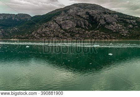 Sarmiento Channel, Chile - December 11, 2008: Amalia Glacier. Ice Pieces Float In Green Melt Water R
