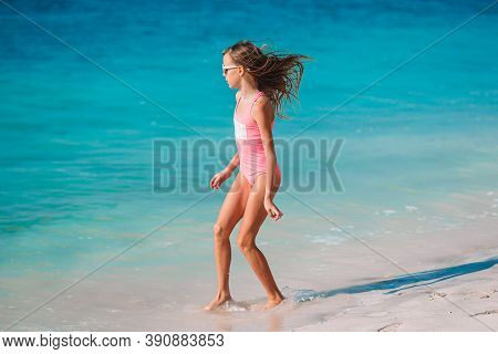 Adorable Active Little Girl At Beach During Summer Vacation