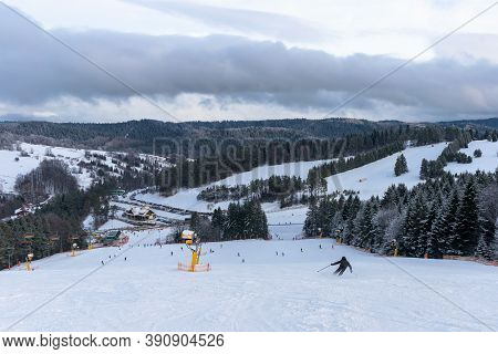 Skiers Go Down The Slope At Slotwiny Arena Ski Station At Snowstorm, Krynica Zdroj, Poland