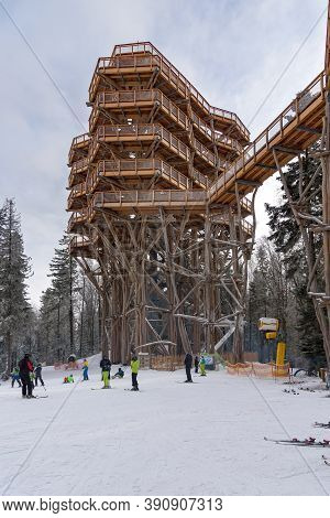 Krynica Zdroj, Poland - January 28, 2020: Skiiers At The Foot Of The Wooden Observation Tower On The