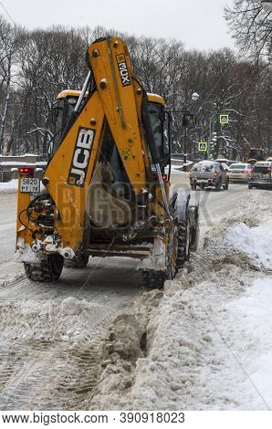 Saint Petersburg, Russia - February 06, 2018: Yellow Tractor Jcb Clearing The Road After A Snowfall