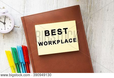 Brown Notepad, Sticker With The Inscription Best Workplase On A Wooden Background. Business Concept.