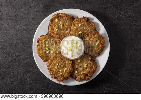 Traditional Jewish Latkes Or Potato Pancakes On Black Background. Top View
