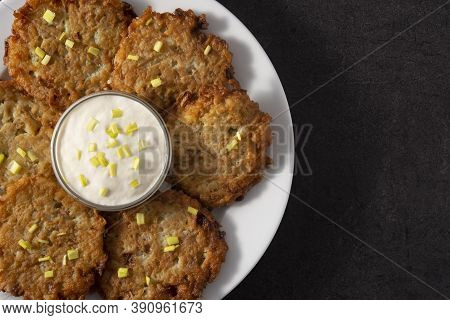 Traditional Jewish Latkes Or Potato Pancakes On Black Background.copy Space