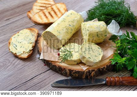 Healthy Butter With Dill, Parsley In The Form Of A Roll, Slices For Easy Use. Herbal Butter On A Cut