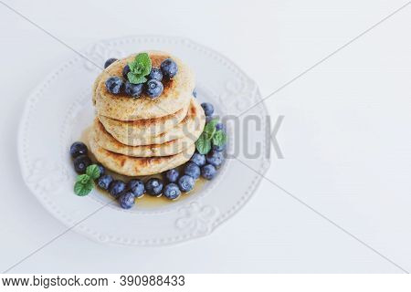 Stack Of Homemade Small Thick Pancakes Served With Fresh Blueberries.