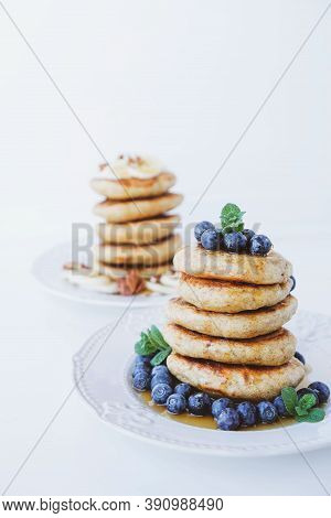 Stack Of Homemade Small Thick Pancakes Served With Fresh Blueberries.