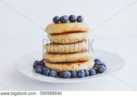 Stack Of Homemade Small Thick Pancakes Served With Fresh Blueberries.