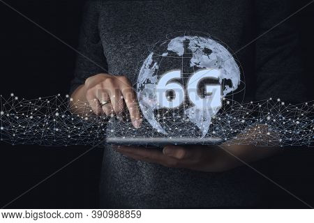 Hand Touch Tablet With Network Hologram 6g. The Concept Of 6g Network, High-speed Mobile Internet