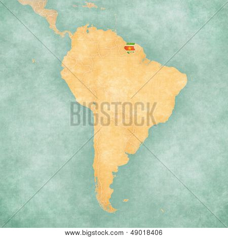 Suriname (Surinamese flag) on the map of South America. The Map is in vintage summer style and sunny mood. The map has a soft grunge and vintage atmosphere which acts as a watercolor painting.