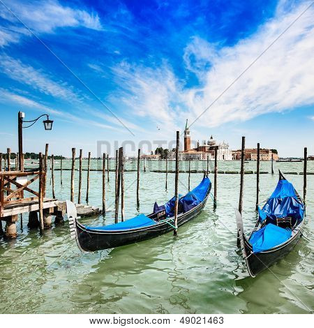 Venice, Gondolas Or Gondole And Church On Background. Italy