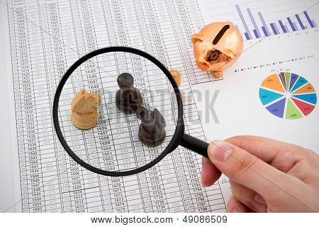Business Concept With Magnifier And Chess Pieces On Colorful Background