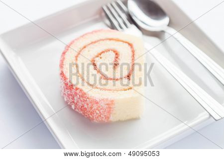 Pink Jam Roll Cake With Spoon And Fork