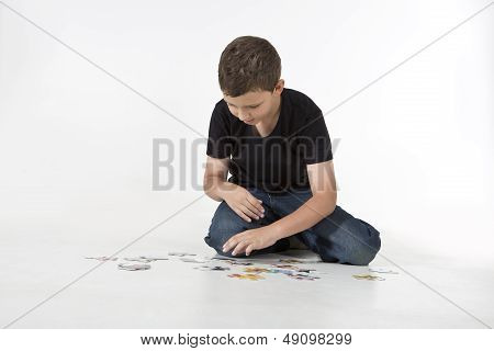 Young boy is working on a puzzle