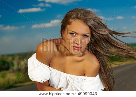 Beautiful  Brunette. Big Blue Sky Background.