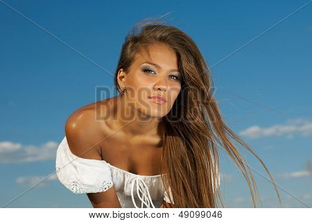Beautiful  Brunette. Big Blue Sky Background.