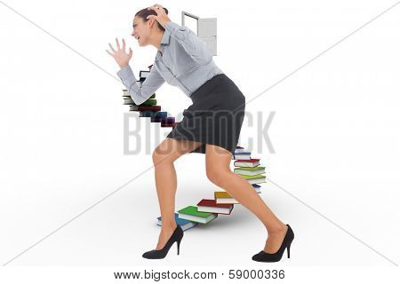 Furious businesswoman gesturing against steps made out of books with open door