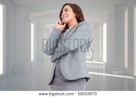 Smiling thoughtful businesswoman against digitally generated room