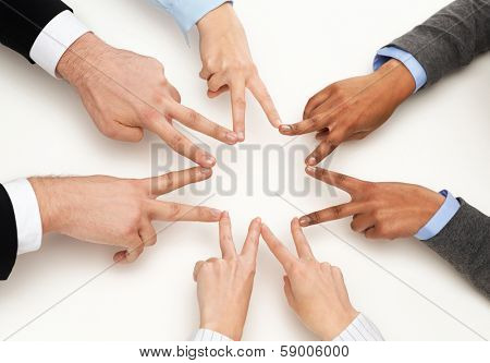 business and succcess concept - group of businesspeople showing v-sign