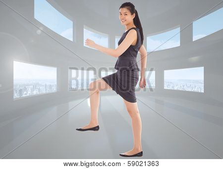 Businesswoman stepping up against bright white room with windows