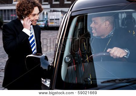 Corporate Guy Interacting With Taxi Driver