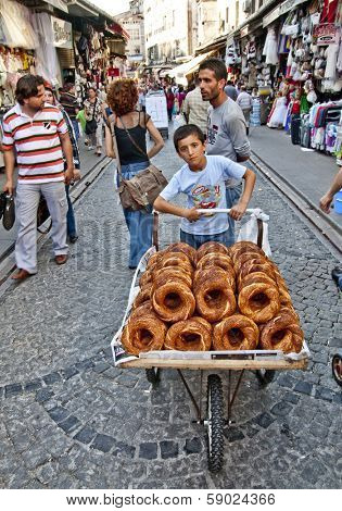 ISTANBUL, TURKEY - JUNE 25, 2010: Grand Bazaar, Unknown Teen sells bagels, June 25, 2010 in Istanbul, Turkey.  Grand Bazaar (founded in 1453) - the largest indoor market in the world.