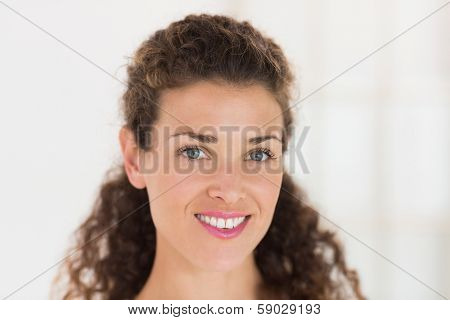 Close-up portrait of beautiful businesswoman smiling in ofiice