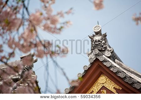 Detail On Japanese Temple Roof Against Blue Sky.