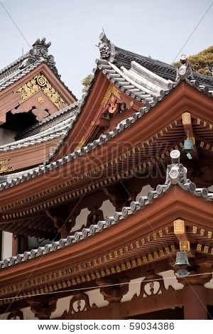 Detail On Japanese Temple Roof Against Blue Sky.