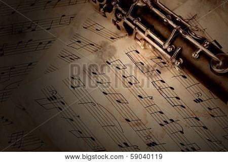 Musical notes and clarinet on wooden table